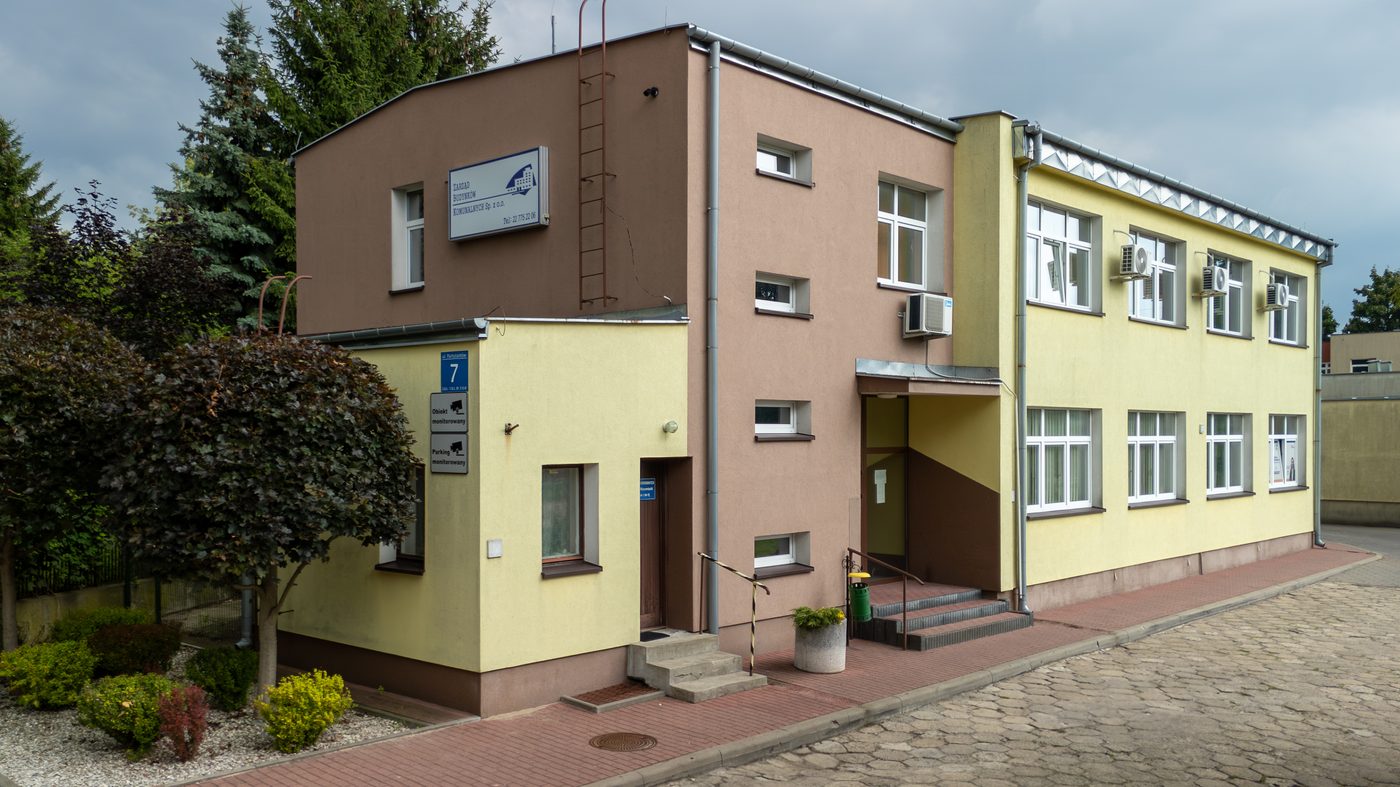 Siedziba Zarządu Budynków Komunalnych przy ulicy Partyzantów 7 w Nowym Dworze Mazowieckim, budynek z żółtą i brązową elewacją